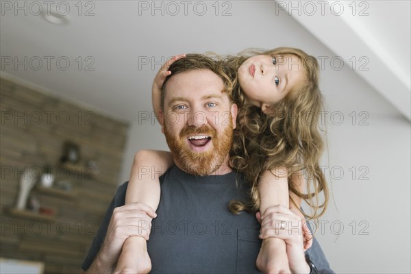 Father carrying daughter