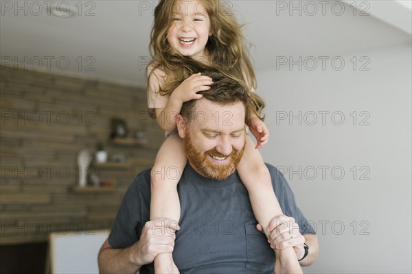 Father carrying daughter