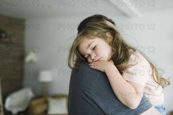 Father holding daughter