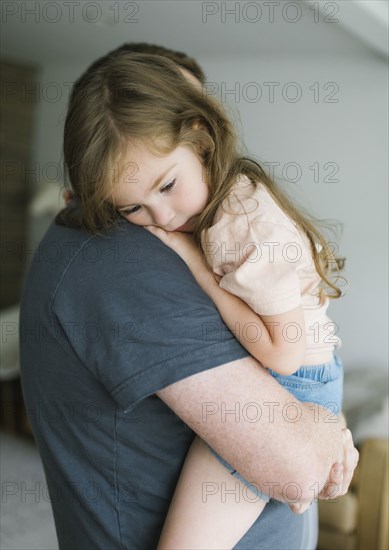 Father holding daughter