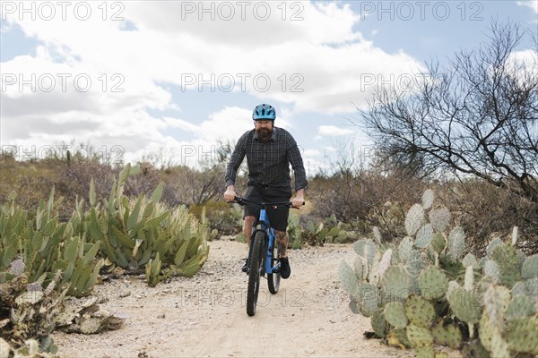 Man riding bike in desert