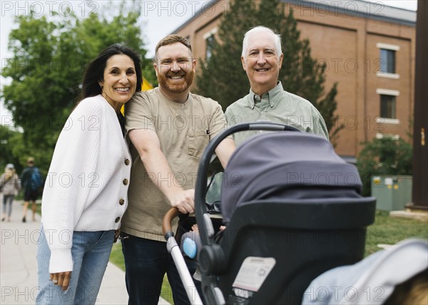 Portrait of family with baby stroller