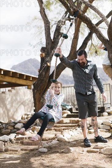 Father swinging daughter