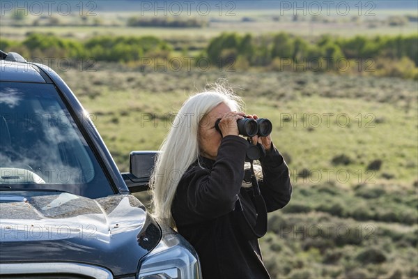 Senior woman using binoculars