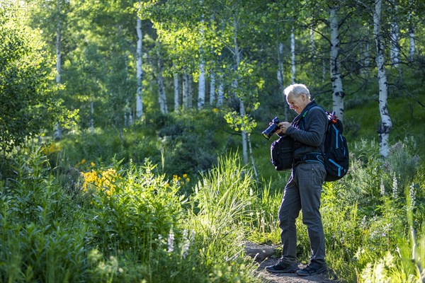 Senior man photographing while hiking in Sun Valley