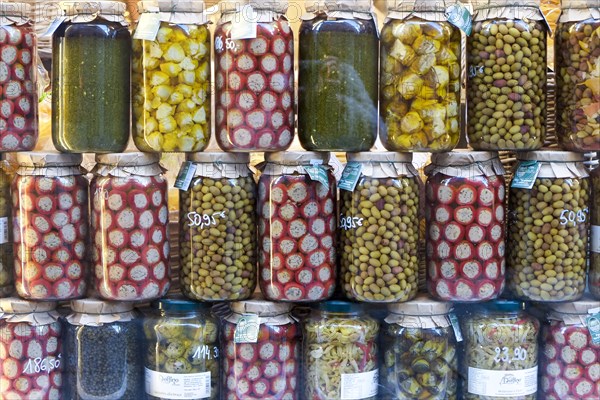 Olives stuffed peppers and marinated vegetables on display