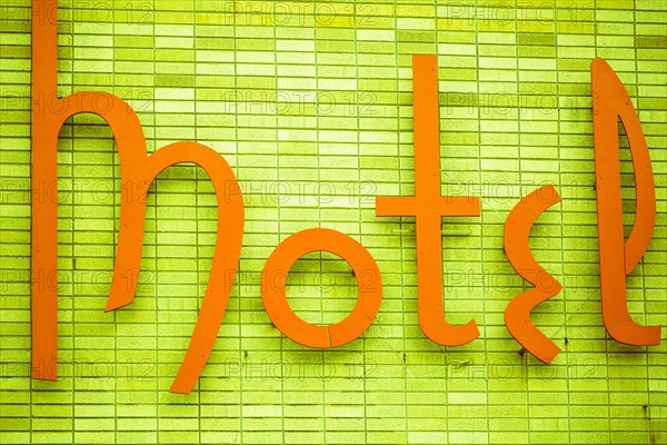 Vintage motel sign on green wall