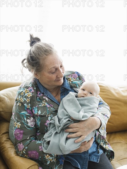 Grandmother holding newborn grandson