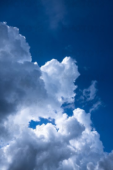 Puffy cumulus clouds against blue sky