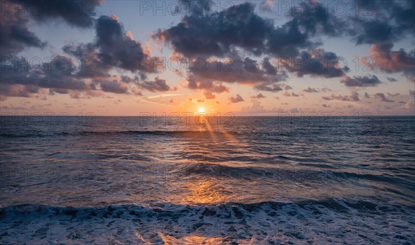 Dramatic sunrise sky above ocean