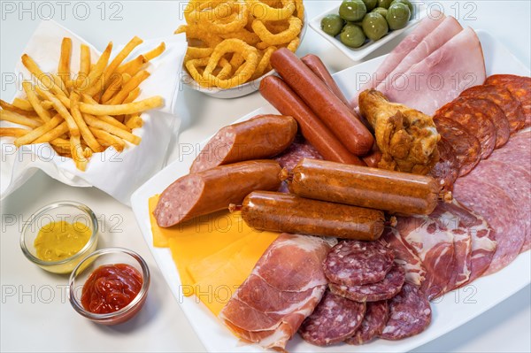 Assorted unhealthy processed and fried foods on table