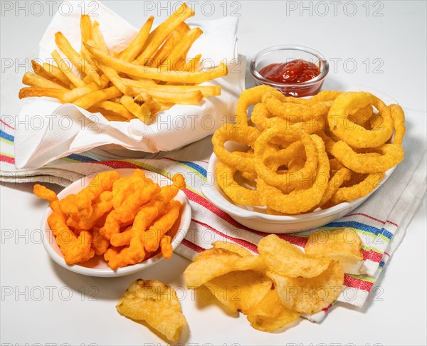 Assorted fattening processed foods on tablecloth