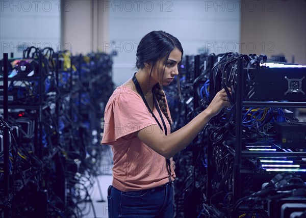 Female technician working in server room