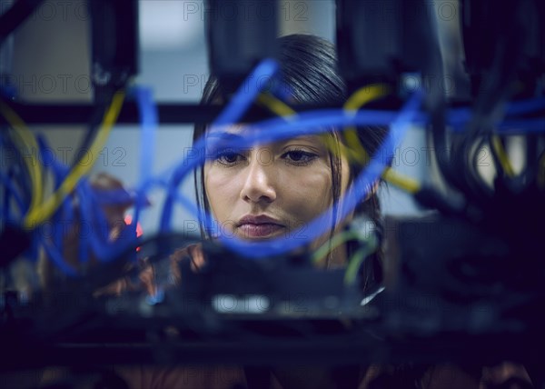 Close-up of female technician working in server room