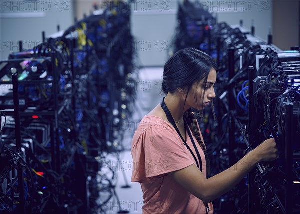 Female technician working in server room