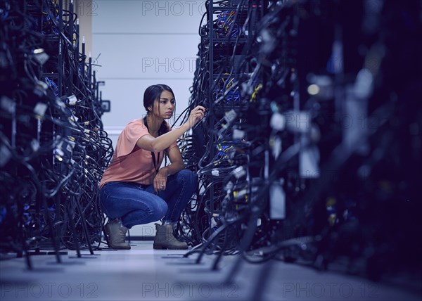 Female technician working in server room