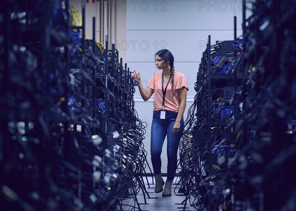 Female technician working in server room