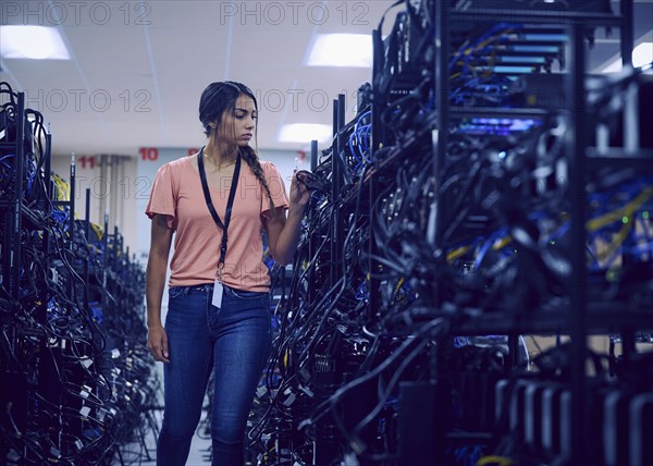 Female technician working in server room