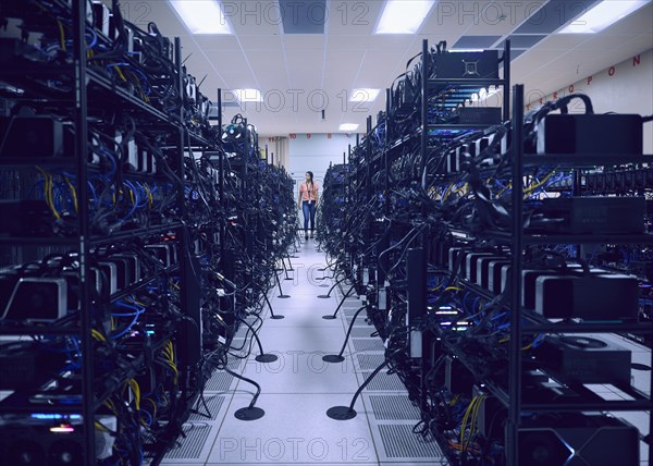 Female technician working in server room