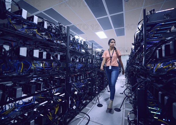 Female technician walking in server room