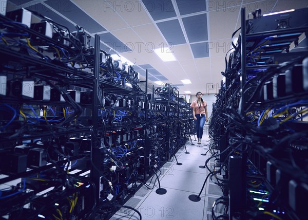 Female technician walking in server room