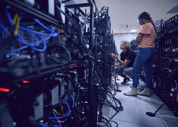 Technicians working in server room