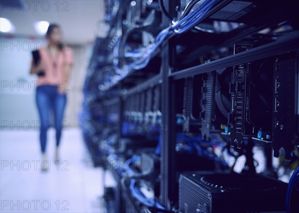 Female technician working in server room