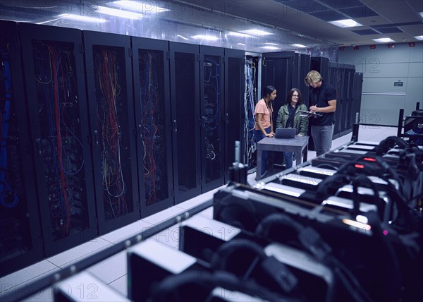 Team of technicians working in server room