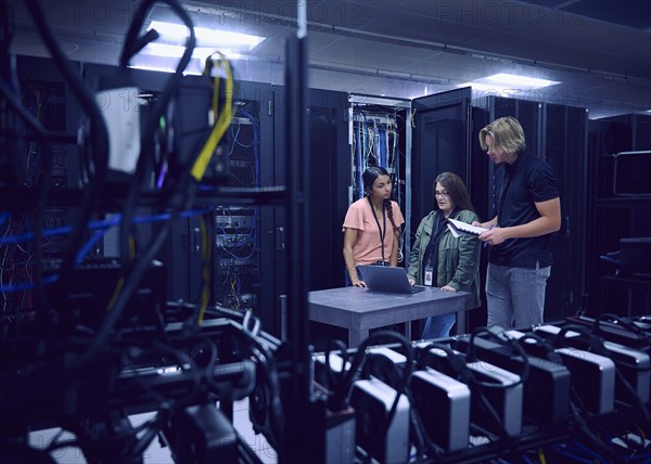 Team of technicians working in server room