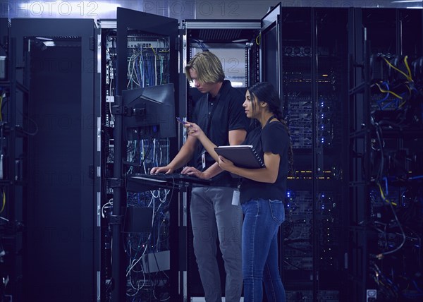 Technicians working in server room