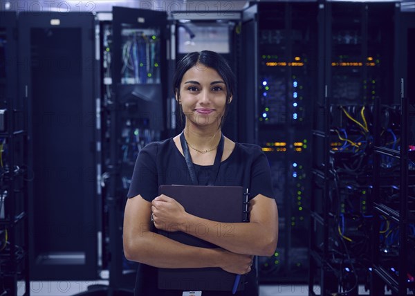 Portrait of smiling female technician in server room
