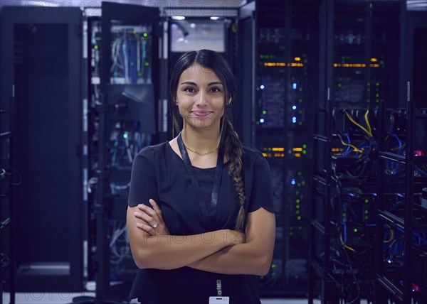 Portrait of smiling female technician in server room