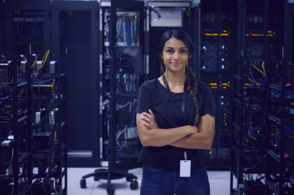 Portrait of smiling female technician in server room