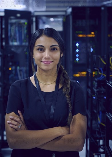 Portrait of smiling female technician in server room