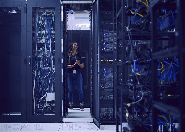 Female technician working in server room