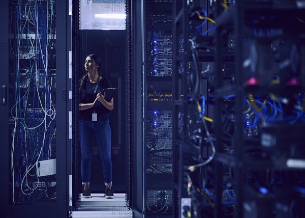 Female technician working in server room