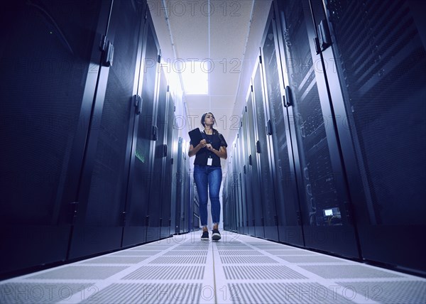 Female technician walking in server room