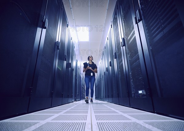 Female technician walking in server room