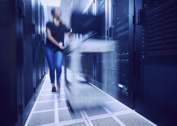 Female technician walking in server room