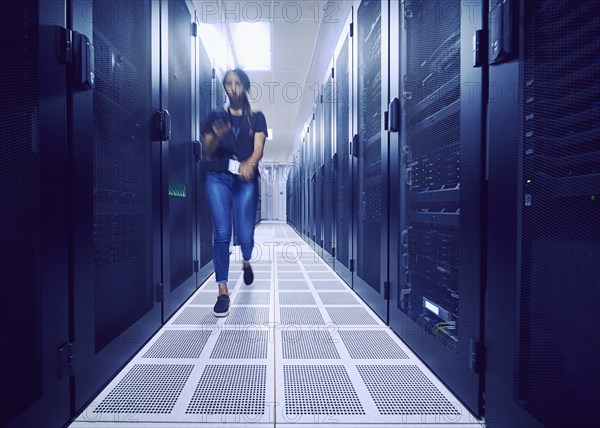 Female technician walking in server room