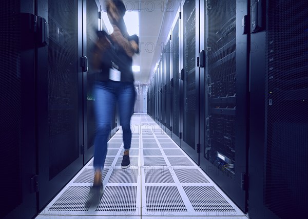 Female technician walking in server room