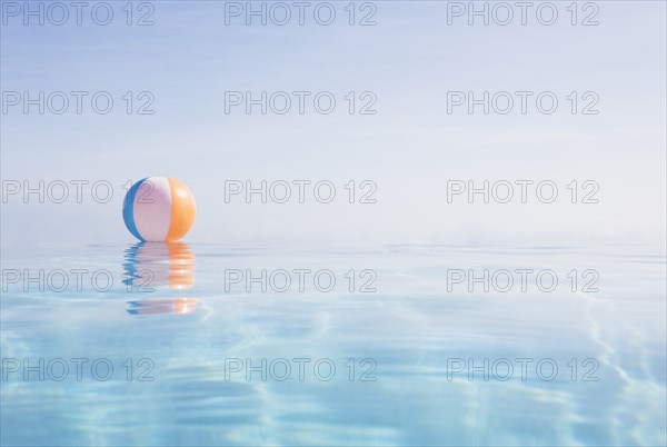 Beach ball floating on water surface