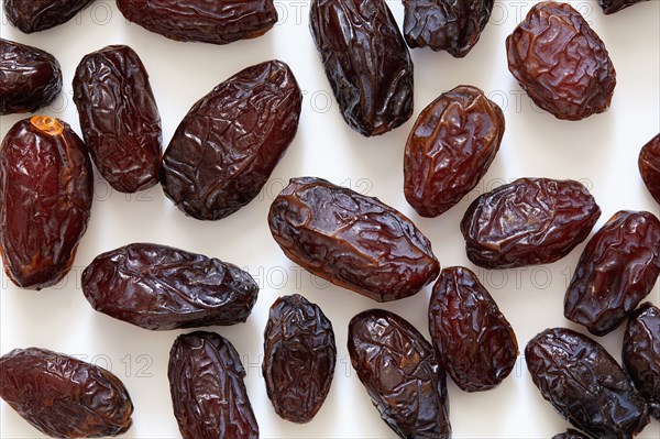 Fresh dried dates on white background