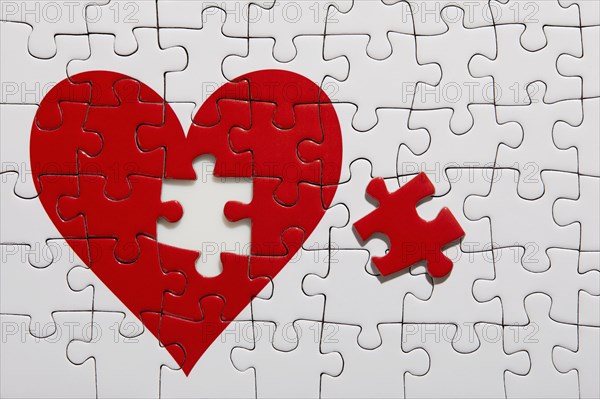 Jigsaw puzzle with red heart