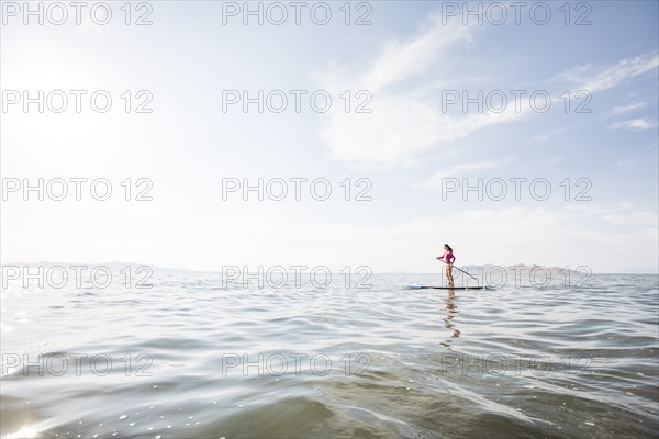 Woman paddleboarding on lake