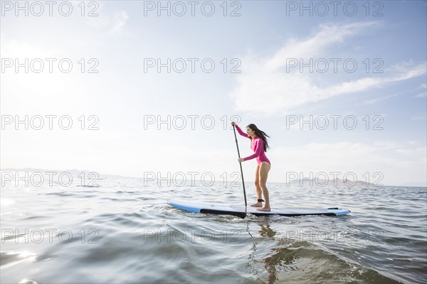 Woman paddleboarding on lake