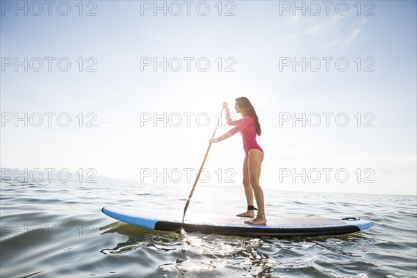 Woman paddleboarding on lake