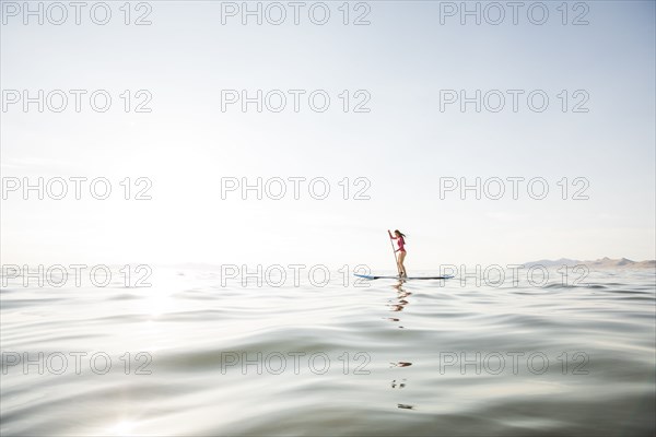 Woman paddleboarding on lake