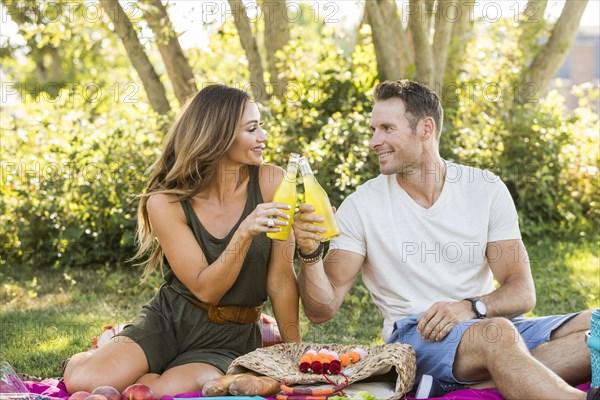 Smiling couple enjoying picnic in park