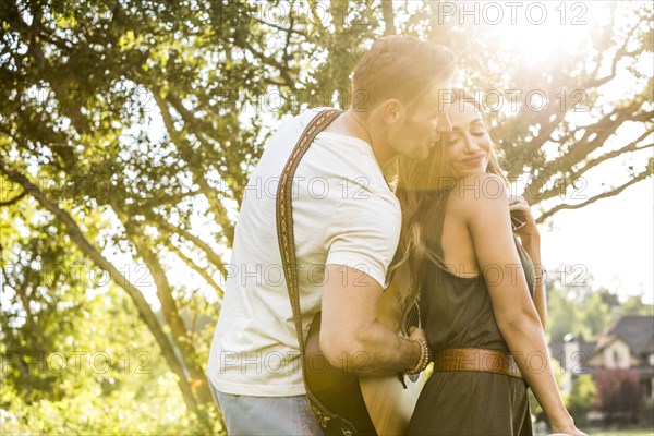 Romantic couple playing guitar and dancing